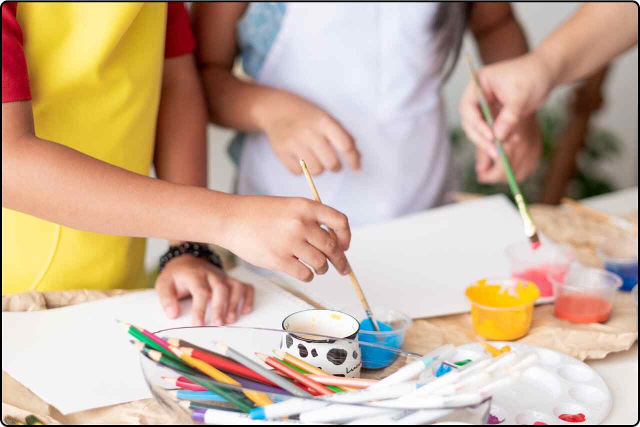 Students engaged in painting exercises, with colorful palettes and brushes in an art classroom